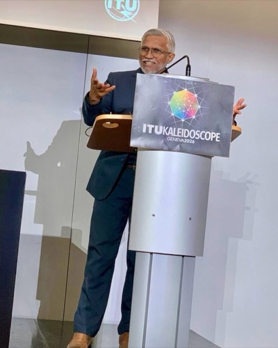 Mohamed Shareef presenting at a lectern bearing the ITU Kaleidoscope Geneva 2026 sign